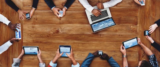 Meeting with many gadgets on table